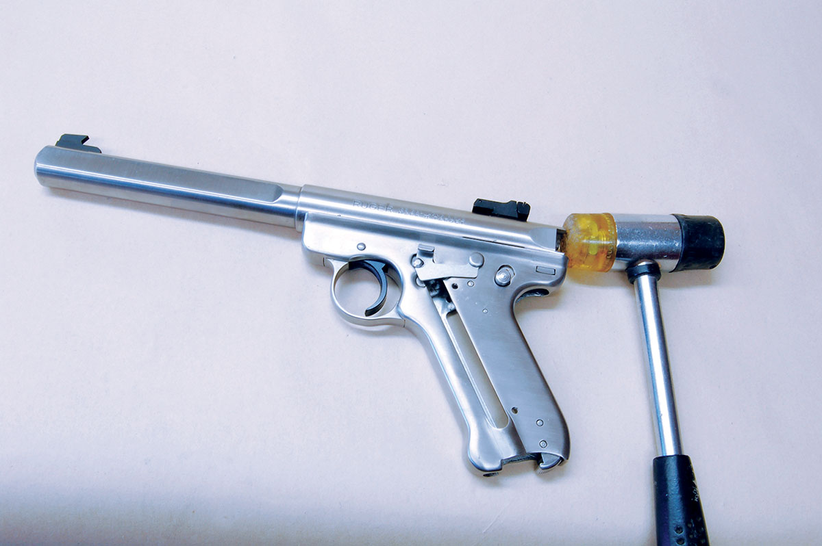 The barrel/receiver is tapped forward off the frame using a soft-faced hammer.
